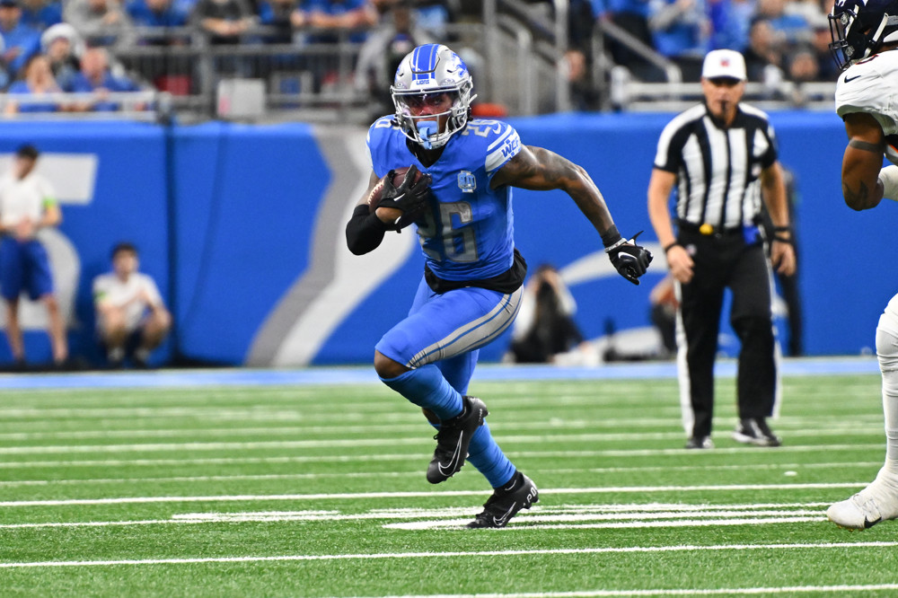 Lions running back Jahmyr Gibbs rushing for a first down