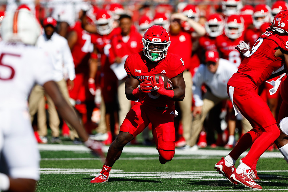 Kyle Monangai runs through a hole created by his offensive line