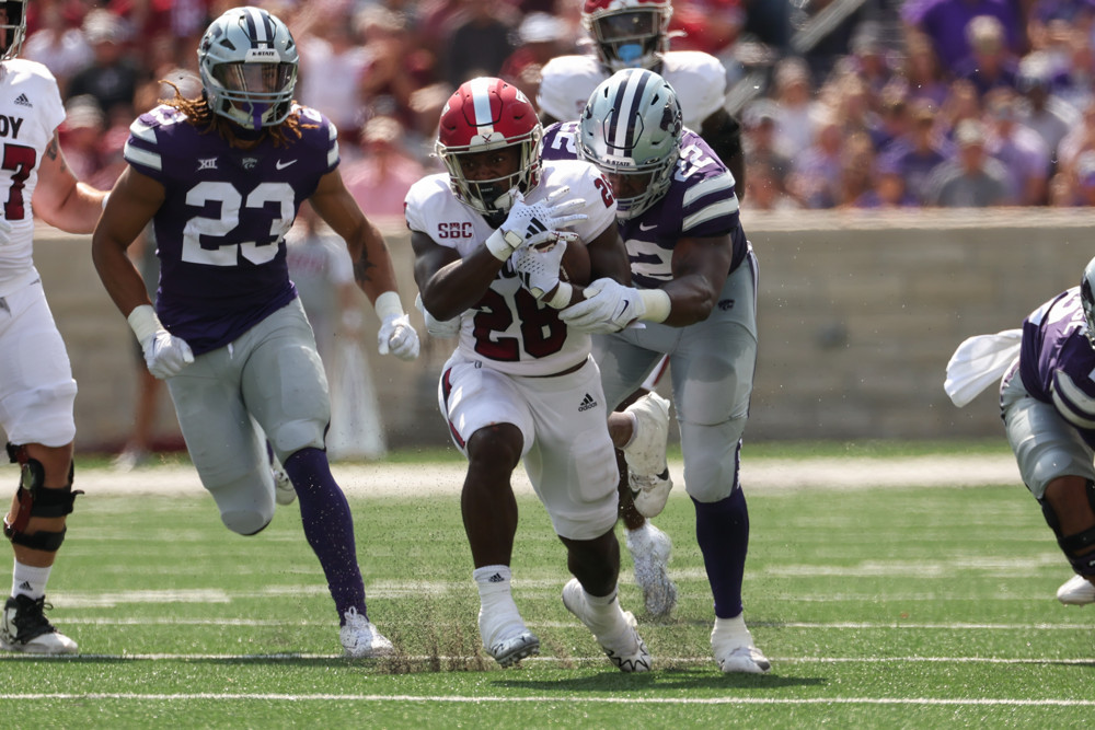 Kimani Vidal runs through a hole and a tackle against Kansas State.