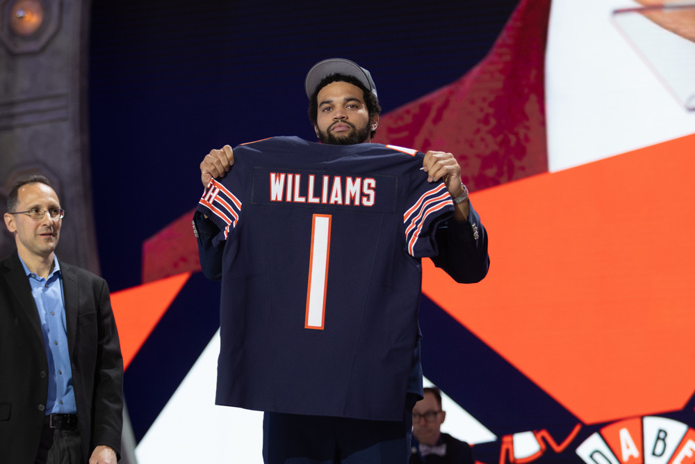Caleb Williams holds his No. 1 Bears jersey.