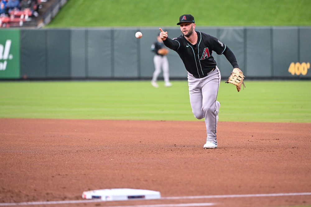 Christian Walker makes an underhand flip towards first base.
