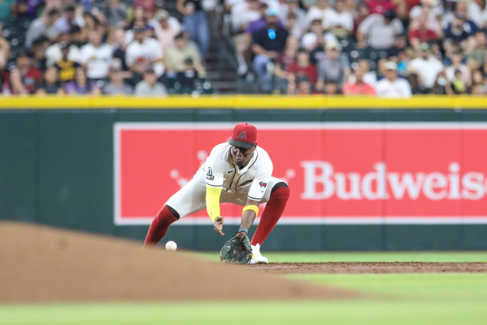Gerlado Perdomo bends over to field a ground ball at shortstop.