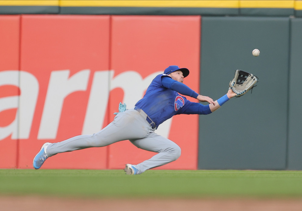 Ian Happ dives and extends his glove hand to try to make a catch