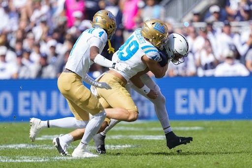 UCLA Bruins Linebacker Carson Schwesinger (49) tackles Penn State Nittany Lions Quarterback Beau Pribula (9) along with UCLA Bruins Defensive Back Bryan Addison