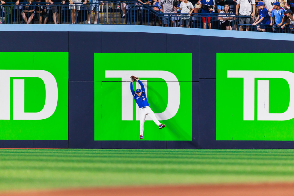 Myles Straw makes a leaoping catch up against the outfield fence