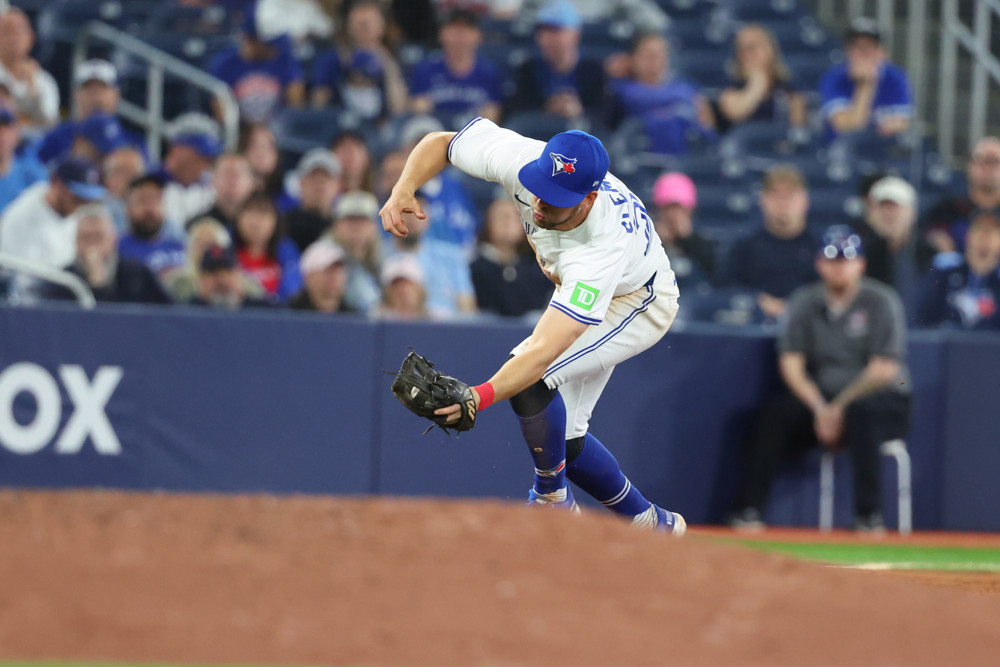 Ernie Clement staggers to field a ground ball at third base.