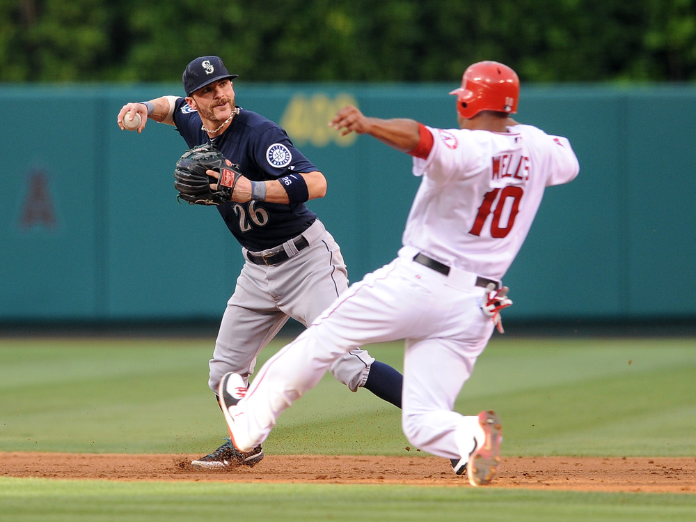 Mariners shortstop Brendan Ryan turns a double play over Angels runner Vernon Wells, who is sliding right into him