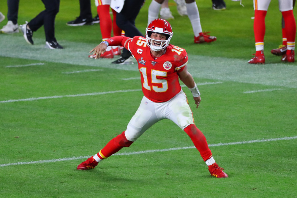 Patrick Mahomes punches the air with his right arm