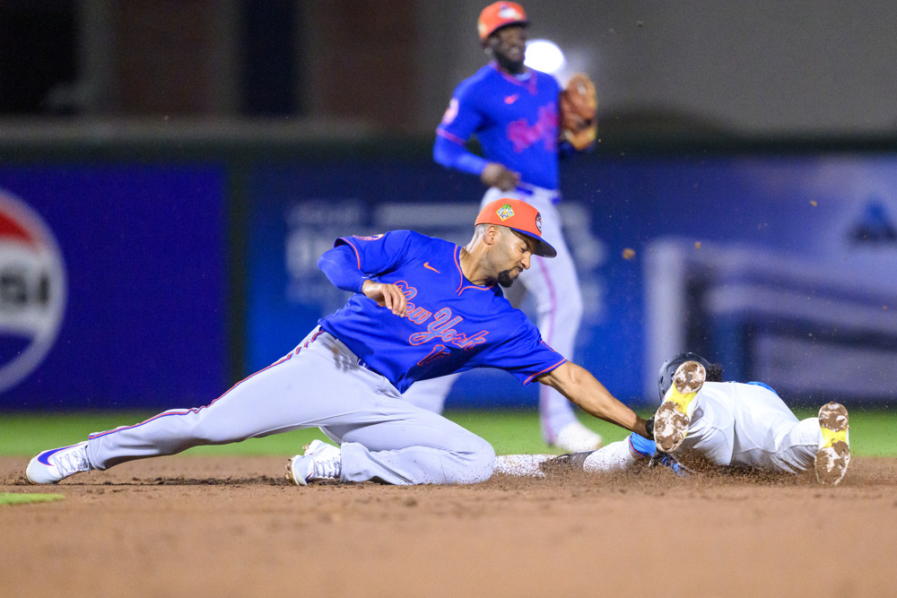 Jalen Duren, wearing a blue Pistons jersey with red No. 8, dunks with his right hand.
