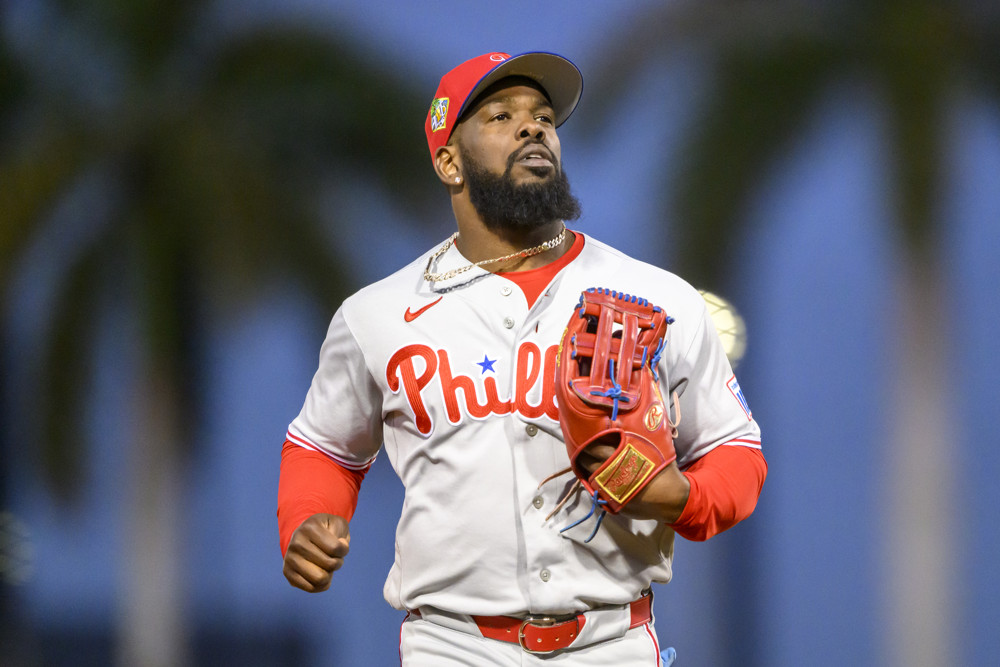 Jalen Duren, wearing a blue Pistons jersey with red No. 8, dunks with his right hand.