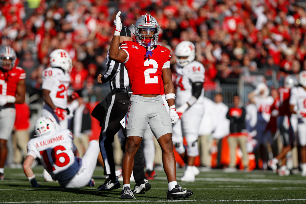 Jalen Duren, wearing a blue Pistons jersey with red No. 8, dunks with his right hand.