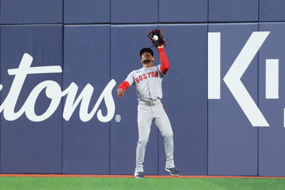 Jalen Duren, wearing a blue Pistons jersey with red No. 8, dunks with his right hand.