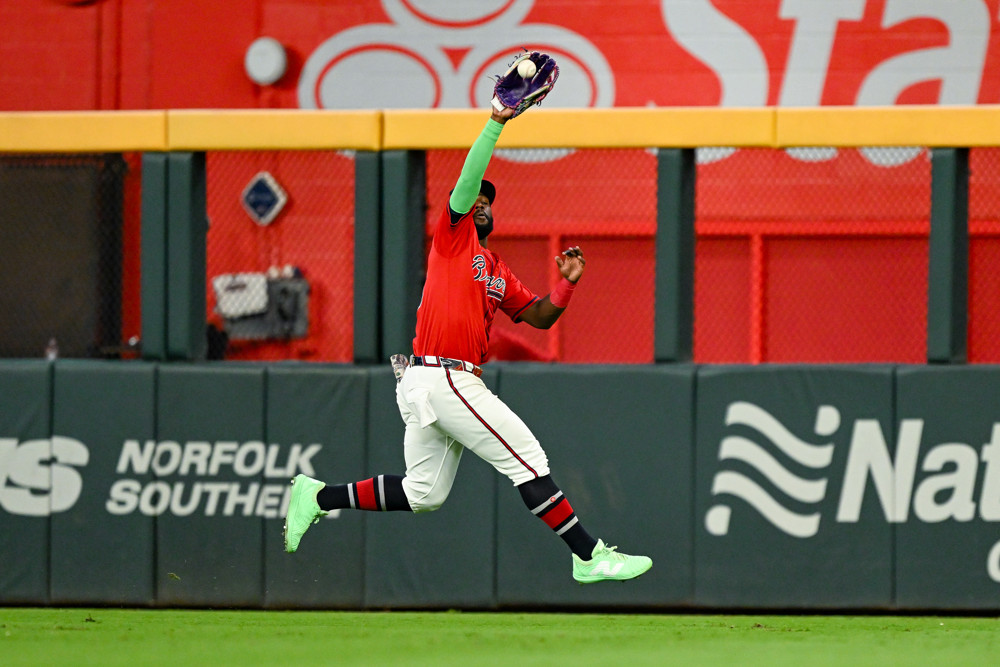 Jalen Duren, wearing a blue Pistons jersey with red No. 8, dunks with his right hand.